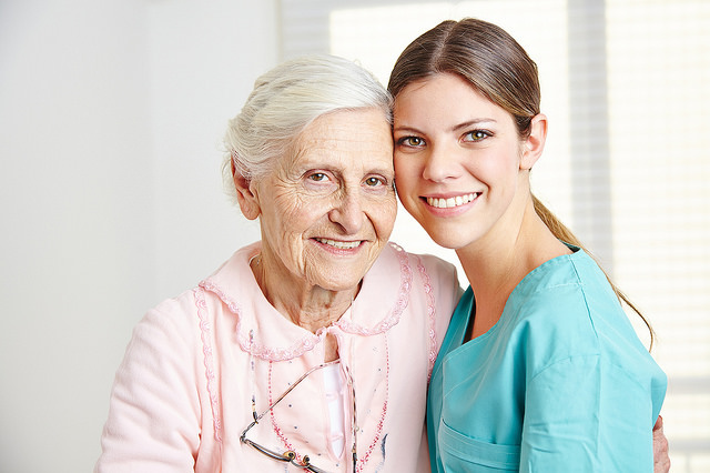 Female nurse caring for elderly woman